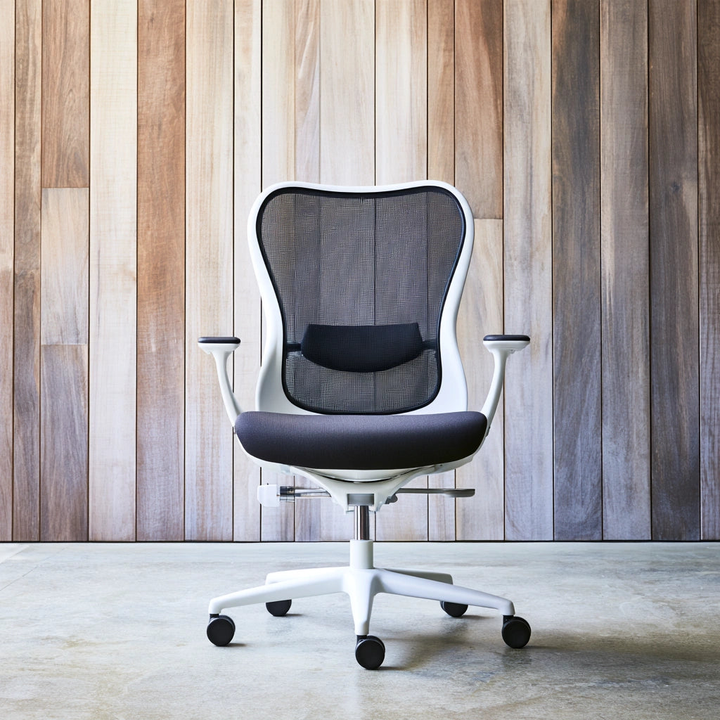 Black and white ergonomic desk chair by Jastira, featuring adjustable height and lumbar support for comfortable office seating.
