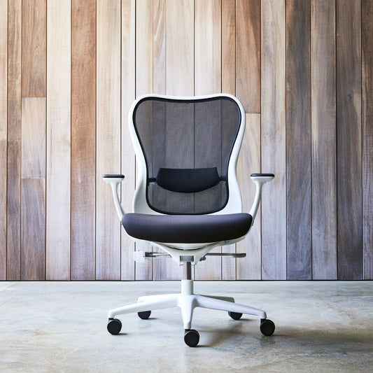 Black and white ergonomic desk chair by Jastira, featuring adjustable height and lumbar support for comfortable office seating.